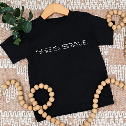 SHE IS. BRAVE Tee