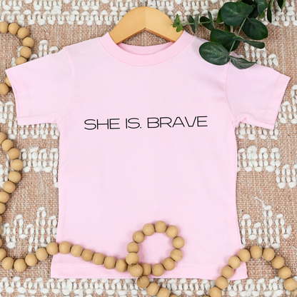 SHE IS. BRAVE Tee